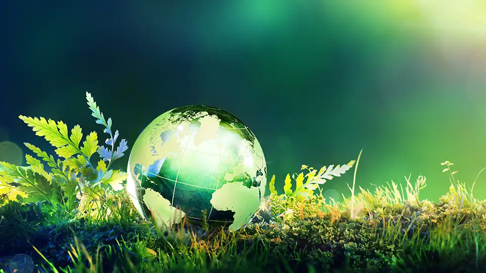 Blog banner image showing a glass globe on green moss - depicting how averting a pump crisis is better for the planet